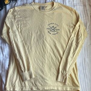 Long sleeve shirt from ocean city. Size small. Yellow and navy blue letters.
